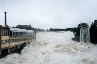 A photo shows the Storelva river flowing through Hoenefoss, Norway on August 9, 2023. Norwegian authorities said on August 9 thousands had been evacuated following massive floods and that they were considering blowing open a dam after the floodgates failed to open. Norway's armed forces said they had been asked to assist police at the Braskereidfoss hydroelectric power station, which lies along the Glomma river -- the longest in Norway -- to evaluate whether the gates would need to be blasted open. (Photo by Annika Byrde / NTB / AFP) / Norway OUT (Photo by ANNIKA BYRDE/NTB/AFP via Getty Images)