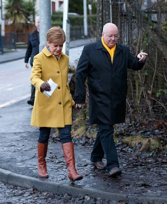 epa08064538 SNP leader Nicola Sturgeon (L) arrives to cast her vote with her husband Peter Murrell (R), during the general elections at Broomhouse Community Hall polling station, Glasgow, Britain, 12 December 2019. Britons go to the polls on 12 December 2019 in a general election to vote for a new parliament.  EPA/ROBERT PERRY