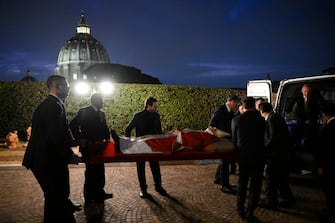 A handout picture provided by the Vatican Media shows the translation of the body of the late Pope Emeritus Benedict XVI (Joseph Ratzinger)  in the Saint Peter's Basilica for public viewing, Vatican City, 02 January 2023. The funeral will take place on Thursday 05 January. 
ANSA/ VATICAN MEDIA +++ ANSA PROVIDES ACCESS TO THIS HANDOUT PHOTO TO BE USED SOLELY TO ILLUSTRATE NEWS REPORTING OR COMMENTARY ON THE FACTS OR EVENTS DEPICTED IN THIS IMAGE; NO ARCHIVING; NO LICENSING +++ (NPK)