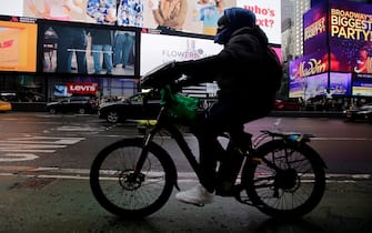NEW YORK, NEW YORK - FEBRUARY 21: A man rides an e-bike through Times Square on February 21, 2023 in New York City. New York City Fire Commissioner Laura Kavanagh has called upon the Consumer Product Safety Commission to take action and help prevent what it calls sub-standard lithium-ion batteries after NYC experienced hundreds of e-bike and e-scooter battery fires. (Photo by Leonardo Munoz/VIEWpress via Getty Images)