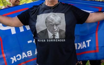 MILWAUKEE, WISCONSIN - JULY 14: A Trump supporter wears a t-shirt with a photo of former President Donald Trump printed on it in Zeidler Union Square during a prayer vigil for him on July 14, 2024 in Milwaukee, Wisconsin. The Republican National Convention runs from July 15-18 in Milwaukee. Security is being increased after the unsuccessful assassination attempt on former president Trump in Pennsylvania on July 13. (Photo by Jim Vondruska/Getty Images)