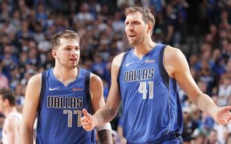DALLAS, TX - APRIL 9: Luka Doncic #77 and Dirk Nowitzki #41 of the Dallas Mavericks talk during the game against the Phoenix Suns on April 9, 2019 at the American Airlines Center in Dallas, Texas. NOTE TO USER: User expressly acknowledges and agrees that, by downloading and or using this photograph, User is consenting to the terms and conditions of the Getty Images License Agreement. Mandatory Copyright Notice: Copyright 2019 NBAE (Photo by Glenn James/NBAE via Getty Images)