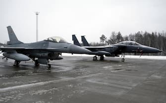 epa09721638 Belgian Air Force F-16 Fighting Falcon (L) and U.S. Air Force McDonnell Douglas F-15 Eagle tactical fighter on display during media day at the NATO Air Policing Mission in the Baltic states enhancement at the Amari Air Base, Estonia, 01 February 2022. NATO allies made the decision to send an augmentation detachment to the NATO Air Policing Mission once again in the context of Russia's further increased tensions along Ukraine's borders and with regard to the necessity to strengthen the security of NATO's eastern allies, Estonia, Latvia, Lithuania, Poland, Romania and Bulgaria.  EPA/VALDA KALNINA