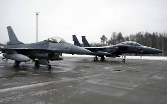 epa09721638 Belgian Air Force F-16 Fighting Falcon (L) and U.S. Air Force McDonnell Douglas F-15 Eagle tactical fighter on display during media day at the NATO Air Policing Mission in the Baltic states enhancement at the Amari Air Base, Estonia, 01 February 2022. NATO allies made the decision to send an augmentation detachment to the NATO Air Policing Mission once again in the context of Russia's further increased tensions along Ukraine's borders and with regard to the necessity to strengthen the security of NATO's eastern allies, Estonia, Latvia, Lithuania, Poland, Romania and Bulgaria.  EPA/VALDA KALNINA