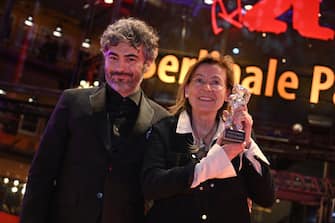25 February 2023, Berlin: Cinematographer Helene Louvart is happy to receive the Silver Bear for Outstanding Artistic Achievement for the film "Disco Boy" alongside Giacomo Abbruzzese, director, after the Berlinale awards ceremony. The 73rd International Film Festival will take place in Berlin from 16 - 26.02.2023. Photo: Fabian Sommer/dpa (Photo by Fabian Sommer/picture alliance via Getty Images)