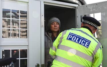Swedish climate activist Greta Thunberg is taken into a police van after being arrested outside the InterContinental London Park Lane during the "Oily Money Out" demonstration organised by Fossil Free London and Greenpeace on the sidelines of the opening day of the Energy Intelligence Forum 2023 in London on October 17, 2023. (Photo by HENRY NICHOLLS / AFP) (Photo by HENRY NICHOLLS/AFP via Getty Images)