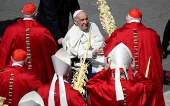 Pope Francis waves at cardinals during the Holy Mass of Palm Sunday in Saint Peter's Square, Vatican City, 24 March 2024. ANSA/RICCARDO ANTIMIANI (Papa, cardinali)