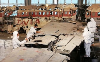 This handout photo shows the boys of the course of Restoration of the Academy of Fine Arts of Bologna at work during the maintenance of the wreck of the Dc9 of Ustica, housed in the Museum for the Memory of the massacre in Bologna, 09 October 2019. The second tranche of the operation, which involved cleaning up the plane's pieces from the dust and degradation that have accumulated in recent years, the safety of tags and labels describing each individual part and a mapping monitoring the retention status of the entire device.  ANSA / us Istituzione Bologna Musei   +++  ANSA PROVIDES ACCESS TO THIS HANDOUT PHOTO TO BE USED SOLELY TO ILLUSTRATE NEWS REPORTING OR COMMENTARY ON THE FACTS OR EVENTS DEPICTED IN THIS IMAGE; NO ARCHIVING; NO LICENSING  +++