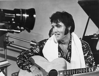 Elvis Presley plays guitar during a scene from the documentary film Elvis: That's the Way It Is.