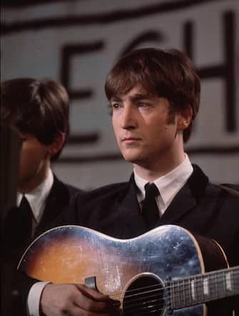 25th November 1963:  John Lennon (1940 - 1980), singer, guitarist and songwriter with the Beatles, plays an acoustic guitar during Granada TV's Late Scene Extra television show filmed in Manchester, England on November 25, 1963.  (Photo by Hulton Archive/Getty Images)