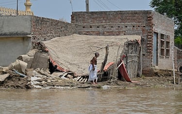 A man stands amid the debris of his house in the flood affected area of Chanda Singh Wala village in Kasur district on August 22, 2023. Around 100,000 people have been evacuated from flooded villages in Pakistan's Punjab province, an emergency services representative said on August 23. (Photo by Arif ALI / AFP) (Photo by ARIF ALI/AFP via Getty Images)