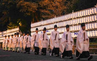 epa11050294 Shinto priests walk past paper lanterns after ending a Shinto ritual in preparation for celebrating the New Year at the inner shrine of Meiji Shrine in Tokyo, Japan, 31 December 2023. It is estimated that about three million people will visit the shrine during the first three days of the New Year 2024 to wish for health and prosperity.  EPA/KIMIMASA MAYAMA