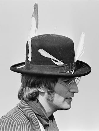 John Lennon (1940-1980), guitarist and singer with the Beatles, pictured wearing hat with feathers attached during filming of 'Magical Mystery Tour' in a field near Newquay in Cornwall on 14th September 1967. (Photo by Chapman/Daily Express/Hulton Archive/Getty Images)