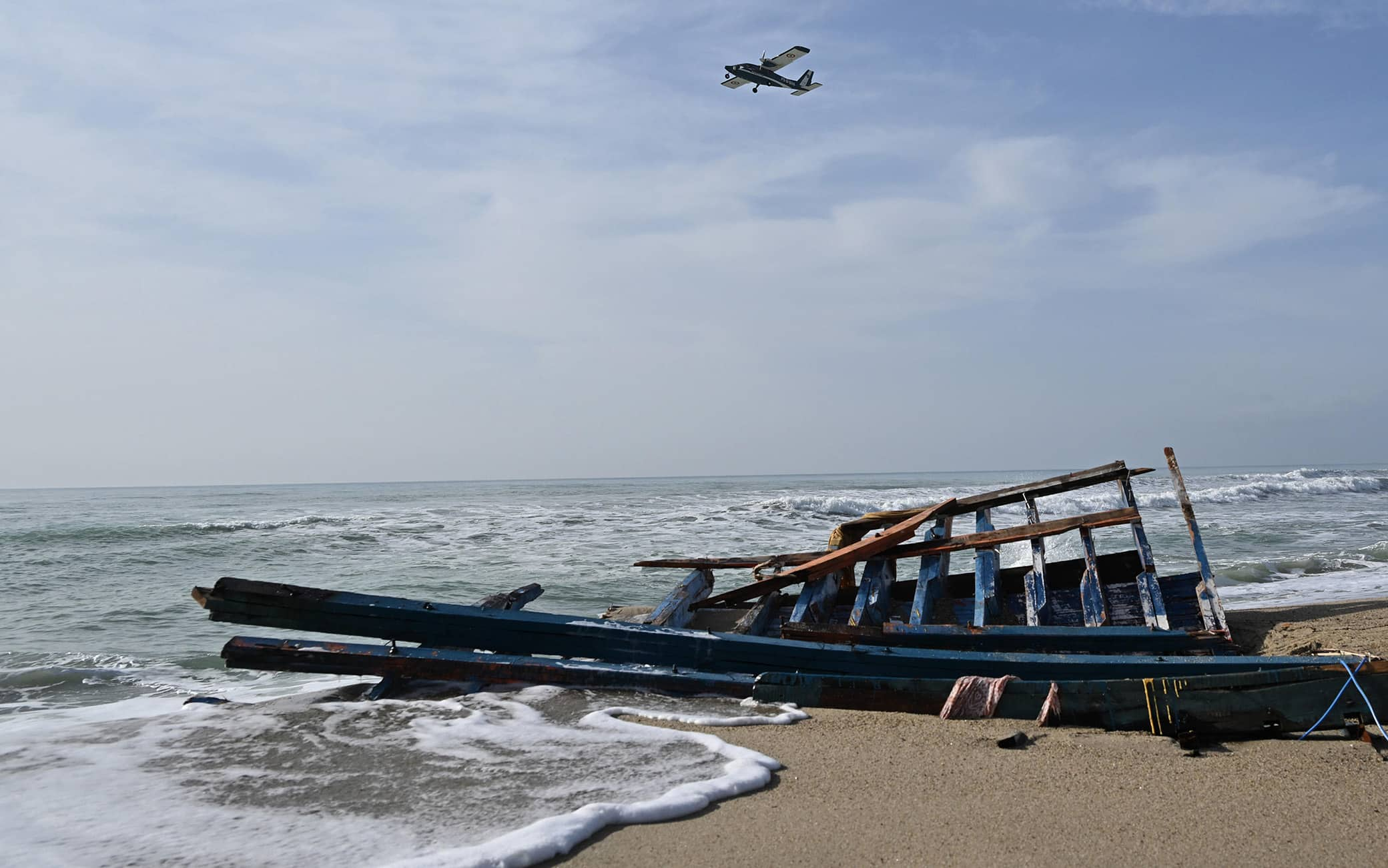 A photograph taken on March 1, 2023 shows clothes, a life vest and pieces of wood washed up on the beach, three days after a boat of migrants sank off Italy's southern Calabria region, in Steccato di Cutro, south of Crotone. - The death toll from a shipwreck off Calabria's coast in southern Italy rose to 67 on 01 March 2023, while three men were in detention accused of human trafficking, Italian officials said. A boat carrying migrants sank in rough seas near the Calabrian coast on 26 February. ANSA/CARMELO IMBESI