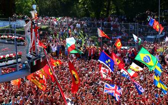 MONZA, ITALY - SEPTEMBER 06:  Lewis Hamilton of Great Britain and Mercedes GP celebrates on the podium next to Sebastian Vettel of Germany and Ferrari after winning the Formula One Grand Prix of Italy at Autodromo di Monza on September 6, 2015 in Monza, Italy.  (Photo by Mark Thompson/Getty Images)
