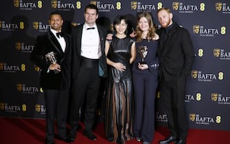 epa11901783 Producer Hayder Rothschild Hoozeer (L), director Franz Boehm (2-L) and Ukrainian actor Oleksandr Rudynskyi (R) pose with guests in the press room after winning the British Short Film award for 'Rock, Paper, Scissors' during the BAFTA Film Awards at the Royal Festival Hall in London, Britain, 16 February 2025. The ceremony is hosted by the British Academy of Film and Television Arts (BAFTA).  EPA/TOLGA AKMEN