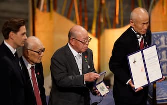 (L-R) The Chair of the Norwegian Nobel Committee Jørgen Watne Frydnes poses with representatives of the 2024 Nobel Peace Prize winner Japan's atomic bomb survivors' group Nihon Hidankyo, Terumi Tanaka, Shigemitsu Tanaka and Toshiyuki Mimaki, at Oslo City Hall after they were awarded the 2024 Nobel Peace Prize on December 10, 2024 in Oslo, Norway. Survivors of the US atomic bombings of Japan received the Nobel Peace Prize 2024 but, after years of anti-nuclear campaigning and showing the world their scars, they still retain the painful memories of the discrimination they have faced. (Photo by Odd ANDERSEN / AFP)