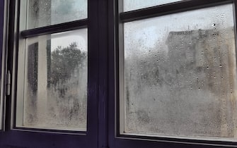 Domestic room with rain droplets on window