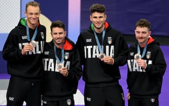 (L-R)  Jonathan Milan, Francesco Lamon, Filippo Ganna and Simone Consonni of Italy celebrate on the podium after winning the bronze medal in the Men's Team Pursuit of the Cycling Track competitions in the Paris 2024 Olympic Games, at Saint-Quentin-en-Yvelines National Velodrome in Saint-Quentin-en-Yvelines, France, 07 August 2024.  ANSA/ETTORE FERRARI