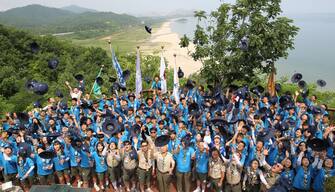 epa05450801 A group of 155 scouts throw up their hats after completing their eight-day traverse of the 248-kilometer truce line bisecting the two Koreas at an observatory in Goseong county, South Korea, 01 August 2016. The annual event, 22nd this year, is designed to help young people realize the reality of the inter-Korean division and inspire the awareness of inter-Korean unification.  EPA/YONHAP SOUTH KOREA OUT