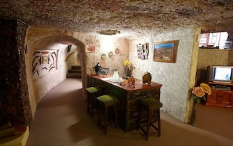 COOBER PEDY, AUSTRALIA - OCTOBER 22:  The bar is seen inside Faye's Underground Home on October 22, 2015 in Coober Pedy, Australia.This three bedroom dugout as locals call underground homes, was hand excavated by Faye Nayler with the help from two of her female friends using picks and shovels. It is still private residence used by the caretakers who run guided tours of the home.  (Photo by Mark Kolbe/Getty Images)