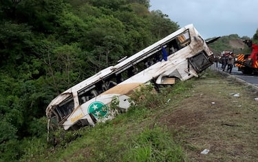 Rescuers work at the site of a road accident in Tepic, Nayarit State, Mexico, on August 3, 2023. At least 18 people were killed and at least 23 injured Thursday when a bus carrying foreign migrants and locals plummeted into a ravine in northwestern Mexico, authorities said. (Photo by Ulises Ruiz / AFP) (Photo by ULISES RUIZ/AFP via Getty Images)