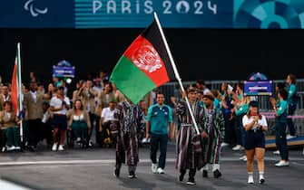 PARIS, FRANCE - AUGUST 28: Flag-bearer Ebrahim Danishi of Afghanistan during the opening ceremony of the Paris 2024 Summer Paralympic Games at Place de la Concorde on August 28, 2024 in Paris, France. (Photo by Gonzalo Fuentes-Pool/Getty Images)