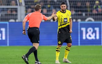 epa11226629 Referee Tobias Stieler (L) first gave Dortmund's Emre Can (R) the red card, than switched to yellow during the German Bundesliga soccer match between Borussia Dortmund and Eintracht Frankfurt in Dortmund, Germany, 17 March 2024.  EPA/CHRISTOPHER NEUNDORF CONDITIONS - ATTENTION: The DFL regulations prohibit any use of photographs as image sequences and/or quasi-video.