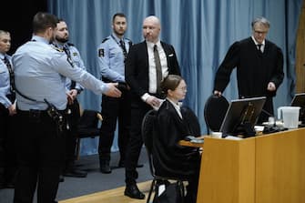 Anders Behring Breivik (3rd R) enters a courtroom at Ringerike prison before the start of his trial over his prison conditions, on January 8, 2024 in Tyristrand, Norway. Breivik, who killed 77 people in a bombing and shooting rampage in 2011 and who has been held apart from other inmates for 12 years, has sued the state for a second time arguing that his isolation is a violation of the European Convention on Human Rights. (Photo by Cornelius Poppe / NTB / AFP) / Norway OUT (Photo by CORNELIUS POPPE/NTB/AFP via Getty Images)