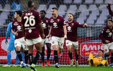 Torino's Italian defender Alessandro Buongiorno (C) celebrates with teammates after he scored the third goal of his team during the Italian Serie A football match Torino vs Napoli at the "Stadio Grande Torino" in Turin on January 7, 2024. (Photo by MARCO BERTORELLO / AFP) (Photo by MARCO BERTORELLO/AFP via Getty Images)