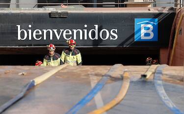 epa11698481 Firefighters exit a flooded underground parking garage at Bonaire mall in Valencia, eastern Spain 03 November 2024. Rains have left more than 200 dead, an undetermined number of missing people, and widespread damage, especially in the province of Valencia. Thousands of volunteers are helping in a day that culminates in the largest deployment of military and security forces personnel in peacetime, according to the Spanish prime minister.  EPA/Manuel Bruque