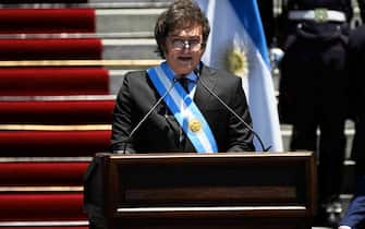 Argentina's new president Javier Milei delivers a speech after swearing in during his inauguration ceremony outside the Congress in Buenos Aires on December 10, 2023. Libertarian economist Javier Milei was sworn in Sunday as Argentina's president, after a resounding election victory fueled by fury over the country's economic crisis. "I swear to God and country... to carry out with loyalty and patriotism the position of President of the Argentine Nation," he said as he took the oath of office, before outgoing President Alberto Fernandez placed the presidental sash over his shoulders. (Photo by Luis ROBAYO / AFP)