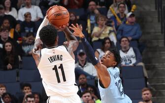 MEMPHIS, TN - OCTOBER 27: Ja Morant #12 of the Memphis Grizzlies attempts to block the shot from Kyrie Irving #11 of the Brooklyn Nets on October 27, 2019 at FedExForum in Memphis, Tennessee. NOTE TO USER: User expressly acknowledges and agrees that, by downloading and or using this photograph, User is consenting to the terms and conditions of the Getty Images License Agreement. Mandatory Copyright Notice: Copyright 2019 NBAE (Photo by Joe Murphy/NBAE via Getty Images)