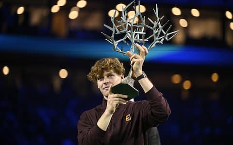 Italy's Jannik Sinner celebrates with the trophy after winning the men's singles final match of the Paris ATP Masters 1000 tennis tournament against Canada's Felix Auger-Aliassime at the Paris La DÃ©fense Arena in Nanterre, on the outskirts of Paris, on November 2, 2025. (Photo by JULIEN DE ROSA / AFP) (Photo by JULIEN DE ROSA/AFP via Getty Images)          