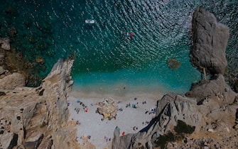 epa08616829 An image taken with a drone shows people enJoy their swimming in the beach 'Seychelles' in the island of Ikaria, Greece, 21 August 2020.  EPA/DIMITRIS TOSIDIS