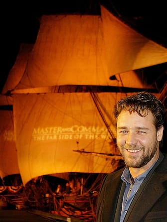 SAN DIEGO - NOVEMBER 9:  Actors Russell Crowe poses for photos in front of the HMS Rose, which was used in the filming of the movie "Master and Commander: The Far Side Of The World", during the film's San Diego premiere November 9, 2003 in San Diego, California. The film was screened on the Broadway Pier in downtown San Diego. The film goes into wide release November 14, 2003.  (Photo by Carlo Allegri/Getty Images)