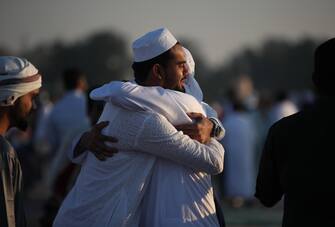 epa10583292 Muslims celebrate and greet each other after attending Eid Al-Fitr prayer at Nad Al Hammar Eid Musalla in Dubai, United Arab Emirates, 21 April 2023. Muslims around the world celebrate Eid al-Fitr, the three day festival marking the end of the Muslim holy month of Ramadan, which is starting on 21 April and some other countries on 22th May depending on the lunar calendar. Eid al-Fitr is one of the two major holidays in Islam.  EPA/ALI HAIDER