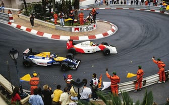 MONTE CARLO, MONACO - MAY 31: Marshals and fans applaud Ayrton Senna, McLaren MP4-7A Honda, and Nigel Mansell, Williams FW14B Renault, at the end of the race following a close finish between the pair during the Monaco GP at Monte Carlo on May 31, 1992 in Monte Carlo, Monaco. (Photo by Rainer Schlegelmilch)