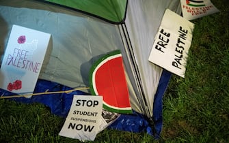 Signs lie next to a tent as pro-Palestinian students and faculty of Drexel University, Temple University and the University of Pennsylvania spend night where they erected an encampment at the University of Pennsylvania campus in Philadelphia on April 25, 2024. College campuses across the US braced for fresh protests by pro-Palestinian students, extending a week of increasingly confrontational standoffs with police, mass arrests and accusations of anti-Semitism. (Photo by Matthew Hatcher / AFP)