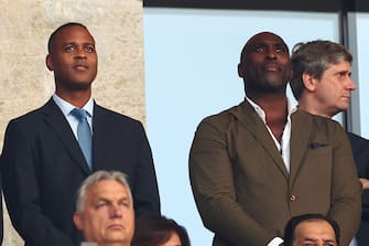 BERLIN, GERMANY - JULY 14:    Sol Cambell & Patrick Kluivert (L) look on prior to the UEFA EURO 2024 final match between Spain and England at Olympiastadion on July 14, 2024 in Berlin, Germany. (Photo by Chris Brunskill/Fantasista/Getty Images)