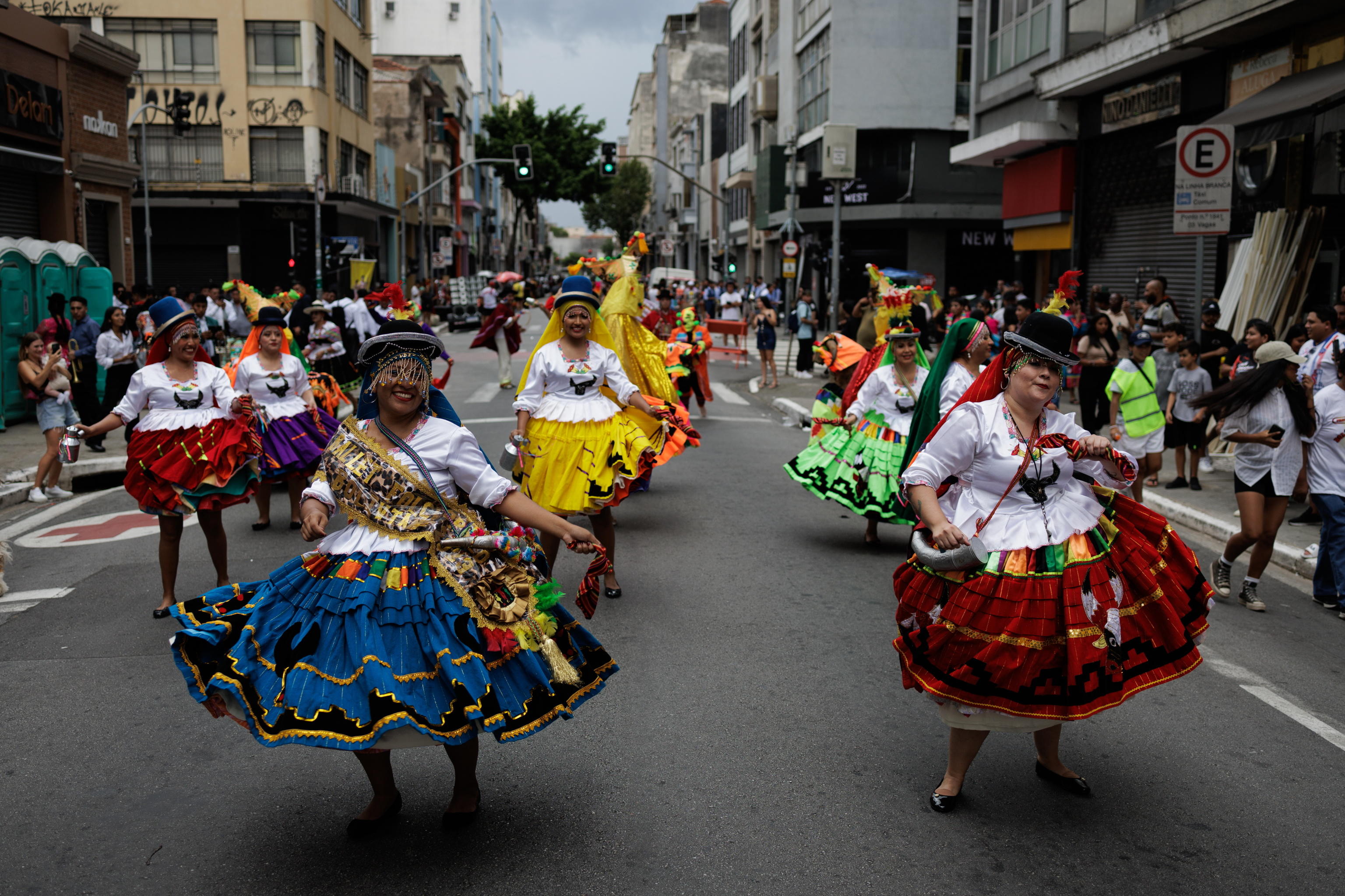 epa11127573 A group of Bolivian expatriates participates in a street parade in Sao Paulo, Brazil, 04 February 2024. The Bolivians of Sao Paulo took to the streets to celebrate Carnival. The highland flute replaced the samba to reclaim the Andean culture in a country where migrants often face prejudice and job insecurity.  EPA/ISAAC FONTANA