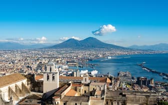 A view of city and Naples port is seen from Vomero in Naples, Italy, on December 7th, 2023. A white cloud above Vesuvio (Vesuvius volcano) is visible on background.  (Photo by Lorenzo Di Cola/NurPhoto via Getty Images)