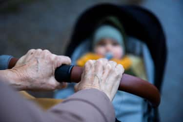 PRODUCTION - 30 January 2023, Berlin: An elderly woman pushes a baby carriage. (Posed scene) Photo: Christoph Soeder/dpa (Photo by Christoph Soeder/picture alliance via Getty Images)