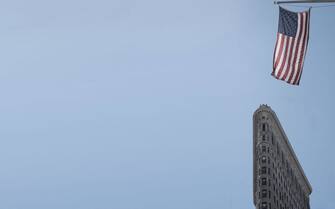 The top of the Flatiron Building on Fifth Avenue, Manhattan, with American flag in foreground 05/07/208 (Photo by Keith Bernstein/Getty Images)