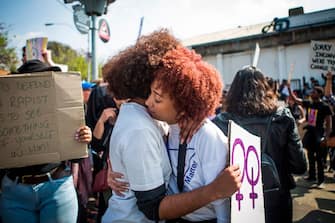 Two women hugs each-other as they part in a protest against the abuse of women in Johannesburg on September 7, 2019, after the murder of Uyinene Mrwetyana, a 19 year-old university student that was raped and killed on August 24, in Cape Town has caused a groundswell of anger and protest against violence against women. (Photo by Guillem SARTORIO / AFP) (Photo by GUILLEM SARTORIO/AFP via Getty Images)