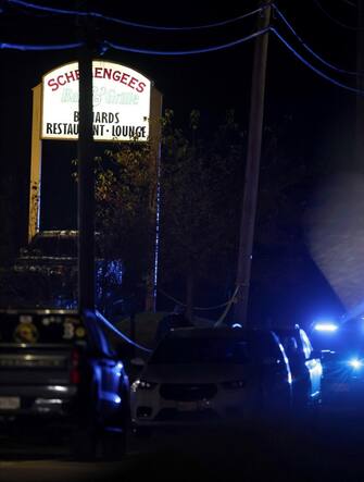 epa10939777 Police cars are parked next to Schemengees bar where a man reportedly opened fire killing and injuring numerous people in Lewiston, Maine, USA, 25 October 2023. Early reports indicate as many as 20 people have been killed, and dozens injured. Police are still searching for the suspect.  EPA/CJ GUNTHER