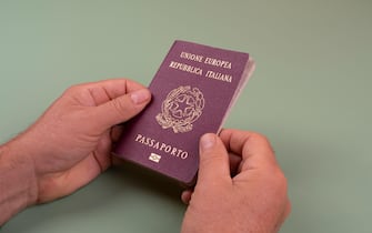 a man with an Italian passport in the hands