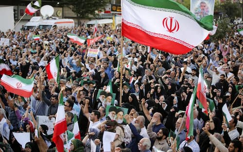 TEHRAN, IRAN - JUNE 22: Crowds holding Iranian flags gather in the Revolution Square in the capital Tehran to protest the US attacks on three nuclear facilities in Iran on June 22, 2025.  In the demonstrations attended by Iranians from many segments of society, they expressed their anger against the US and Israel. (Photo by Fatemeh Bahrami/Anadolu via Getty Images)