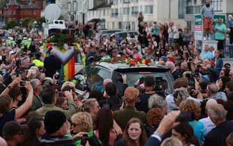 Fans of singer Sinead O'Connor line the streets for a "last goodbye" to the Irish singer as her funeral cortege passes through her former hometown of Bray, Co Wicklow, ahead of a private burial service. Picture date: Tuesday August 8, 2023.