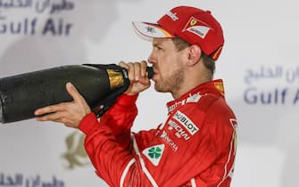 Bahrain International Circuit, Sakhir, Bahrain. 
Sunday 16 April 2017.
Sebastian Vettel, Ferrari, 1st Position, tastes the rose water Champagne substitute on the podium.
World Copyright: Charles Coates/LAT Images
ref: Digital Image _27I1199